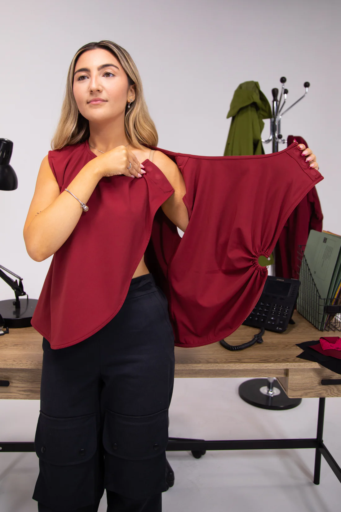 Woman demonstrates the magnetic wrap top in red